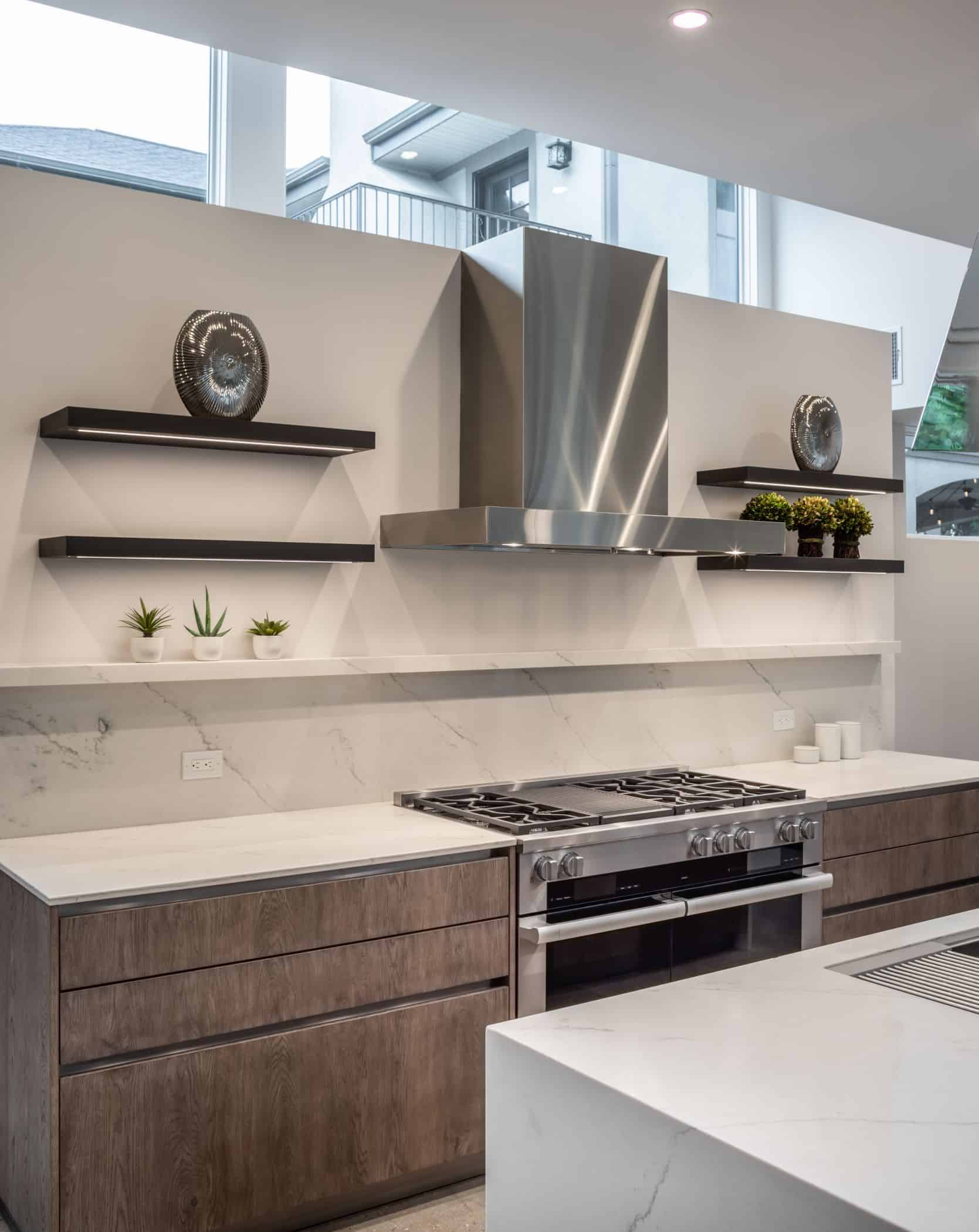 stove with raised ledge detail and display shelves in a washington coalition memorial park area home in houston