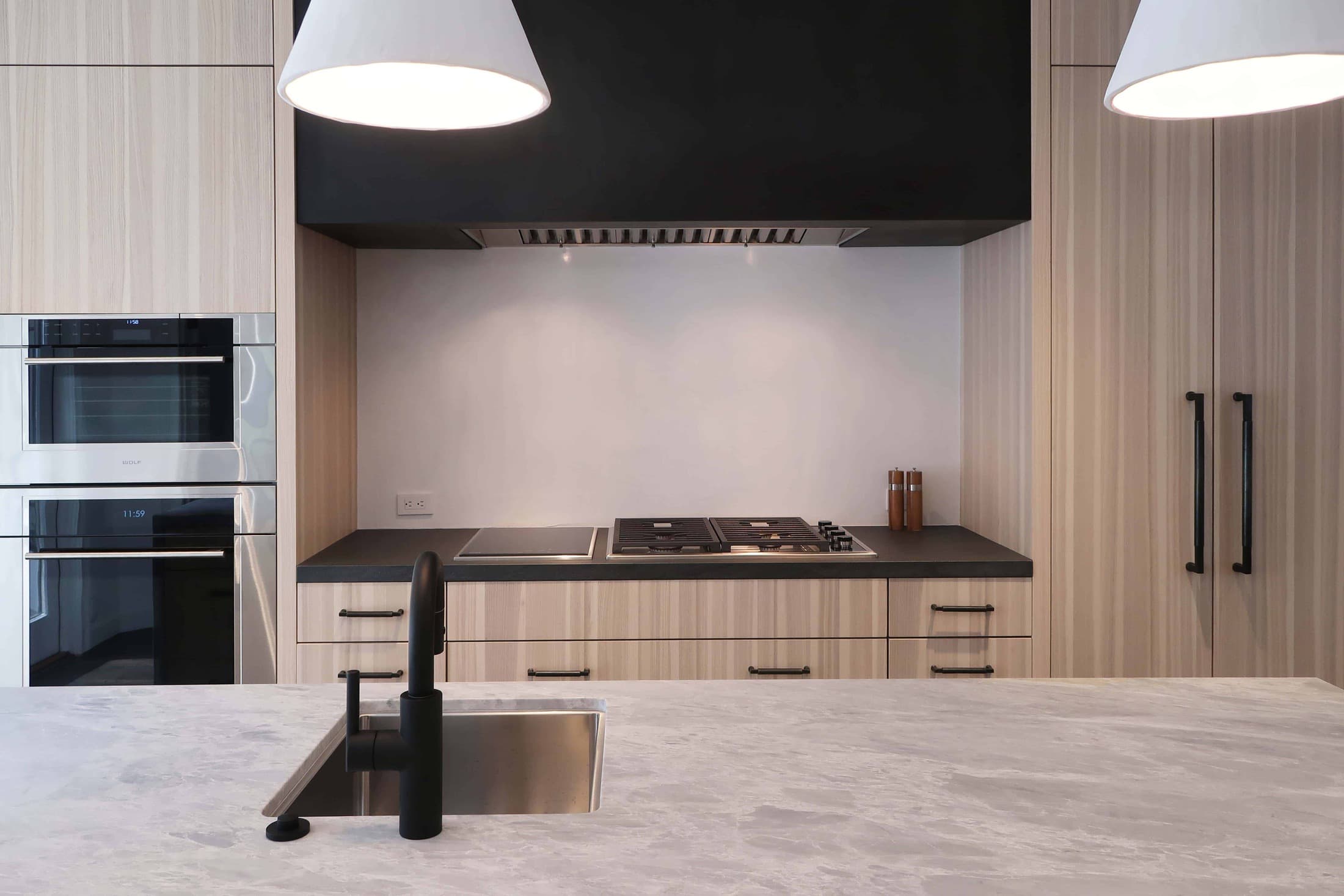 after picture of the sink and appliance wall of a modern eggersmann kitchen with traditional touches created in a hancock park traditional home in los angeles