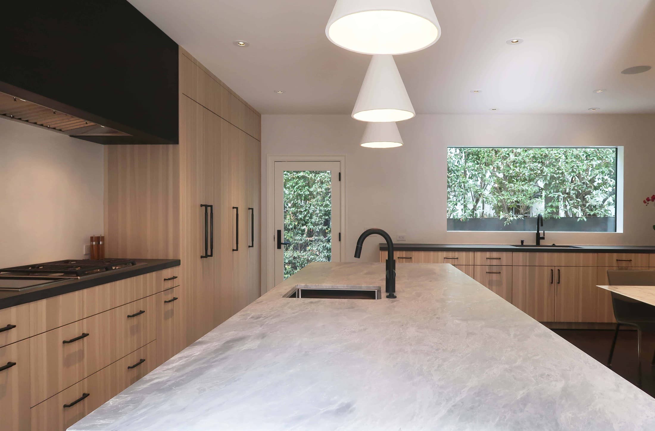 after picture of the island of a modern eggersmann kitchen with traditional touches created in a hancock park traditional home in los angeles