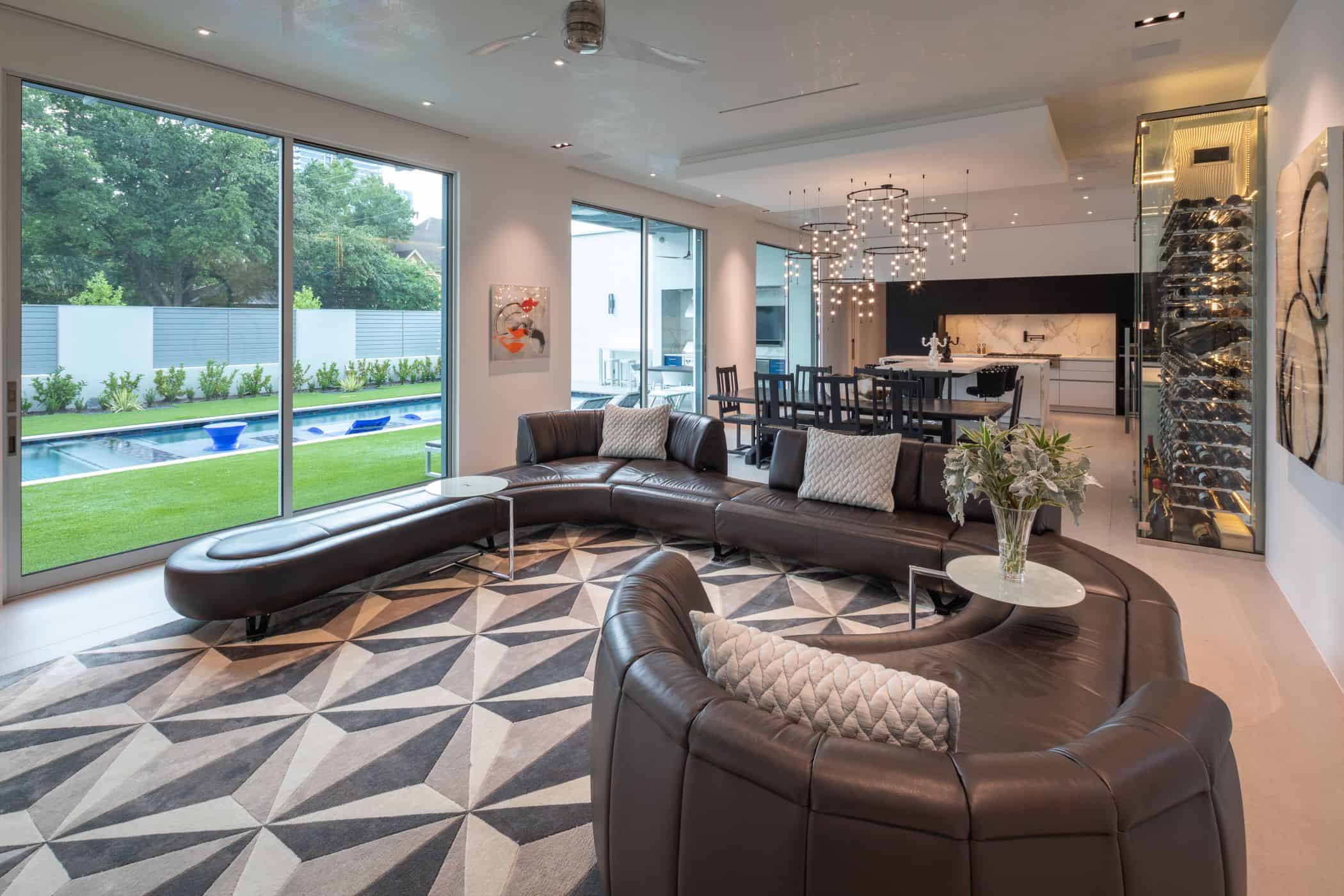 great room off the eggersmann black and white kitchen of a master bedroom of a houston new construction home in the upper kirby community