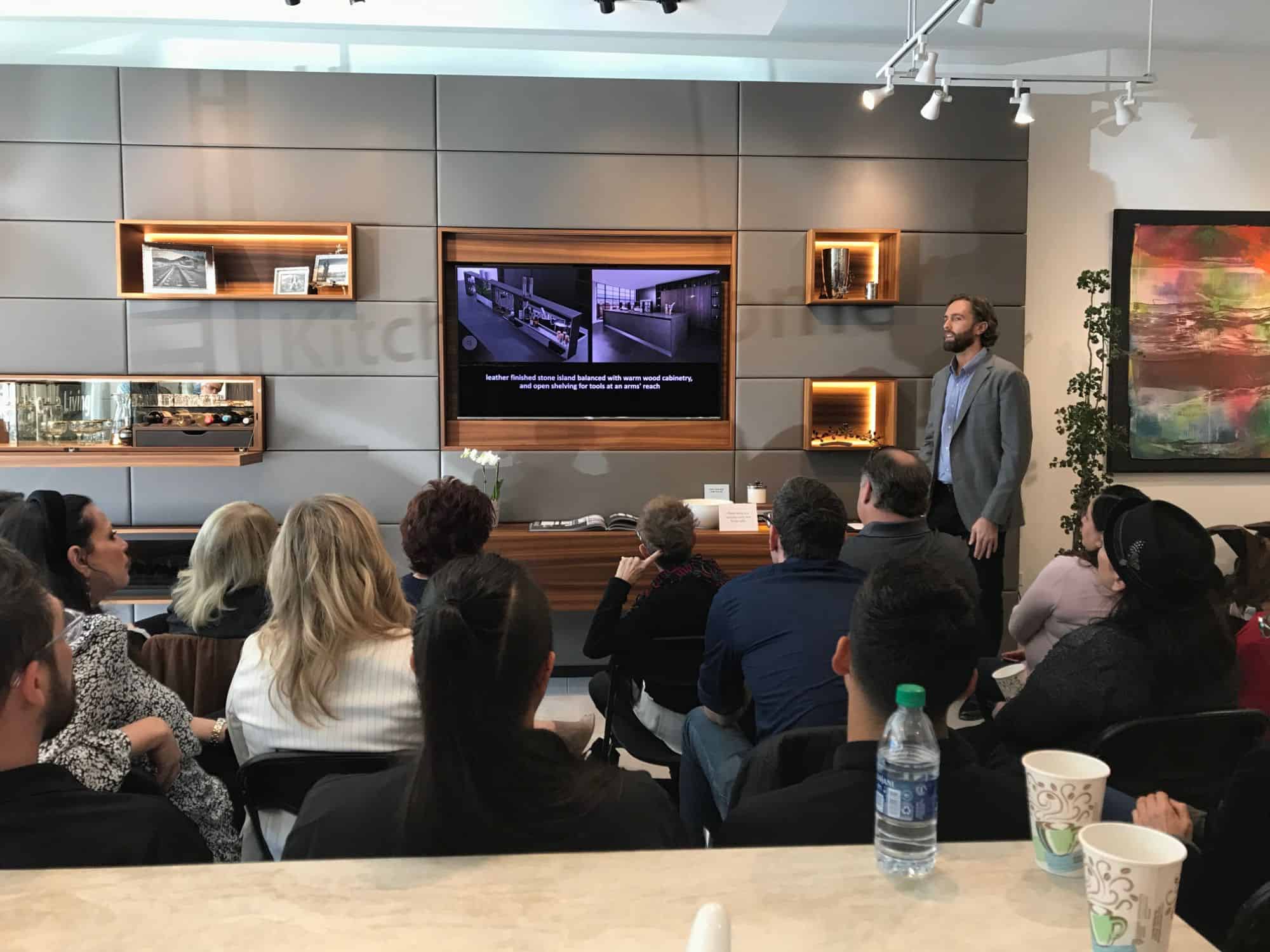 attendees learning from a video presentation in an estate master class