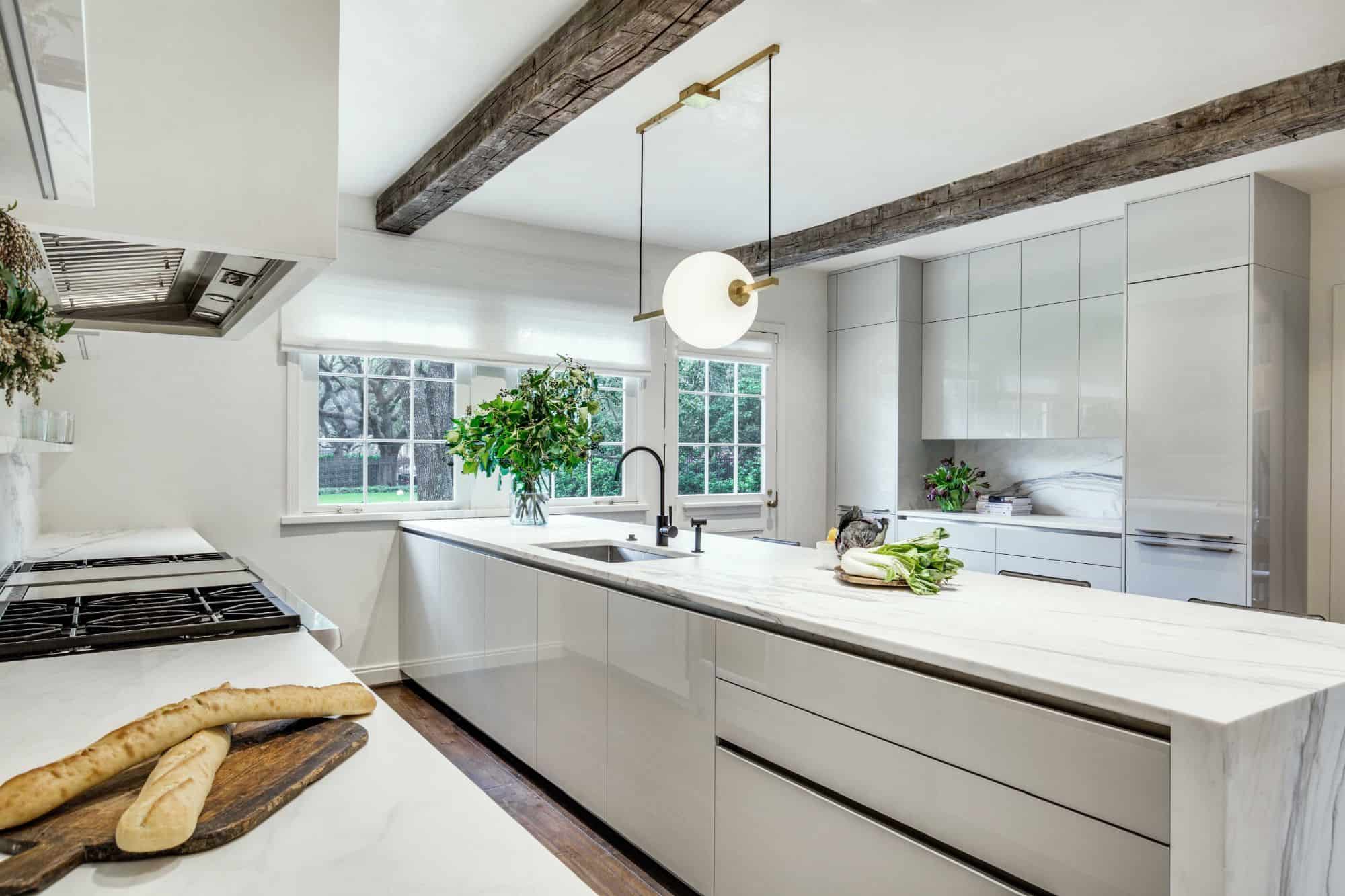 Green plants like these in this luxury stone kitchen add a natural feel that boosts your creativity