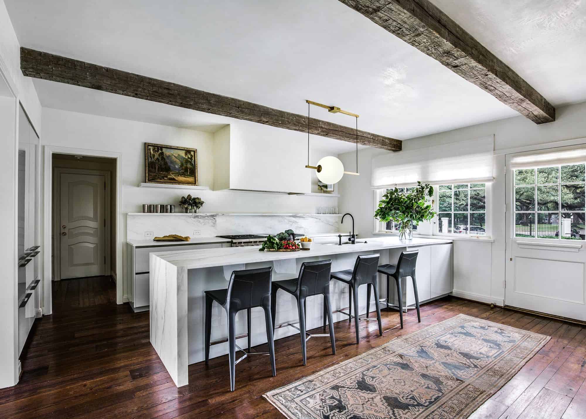 light bright marble kitchen accented by rough hewn beams and antique floor on eggersmann's modern cabinetry collection