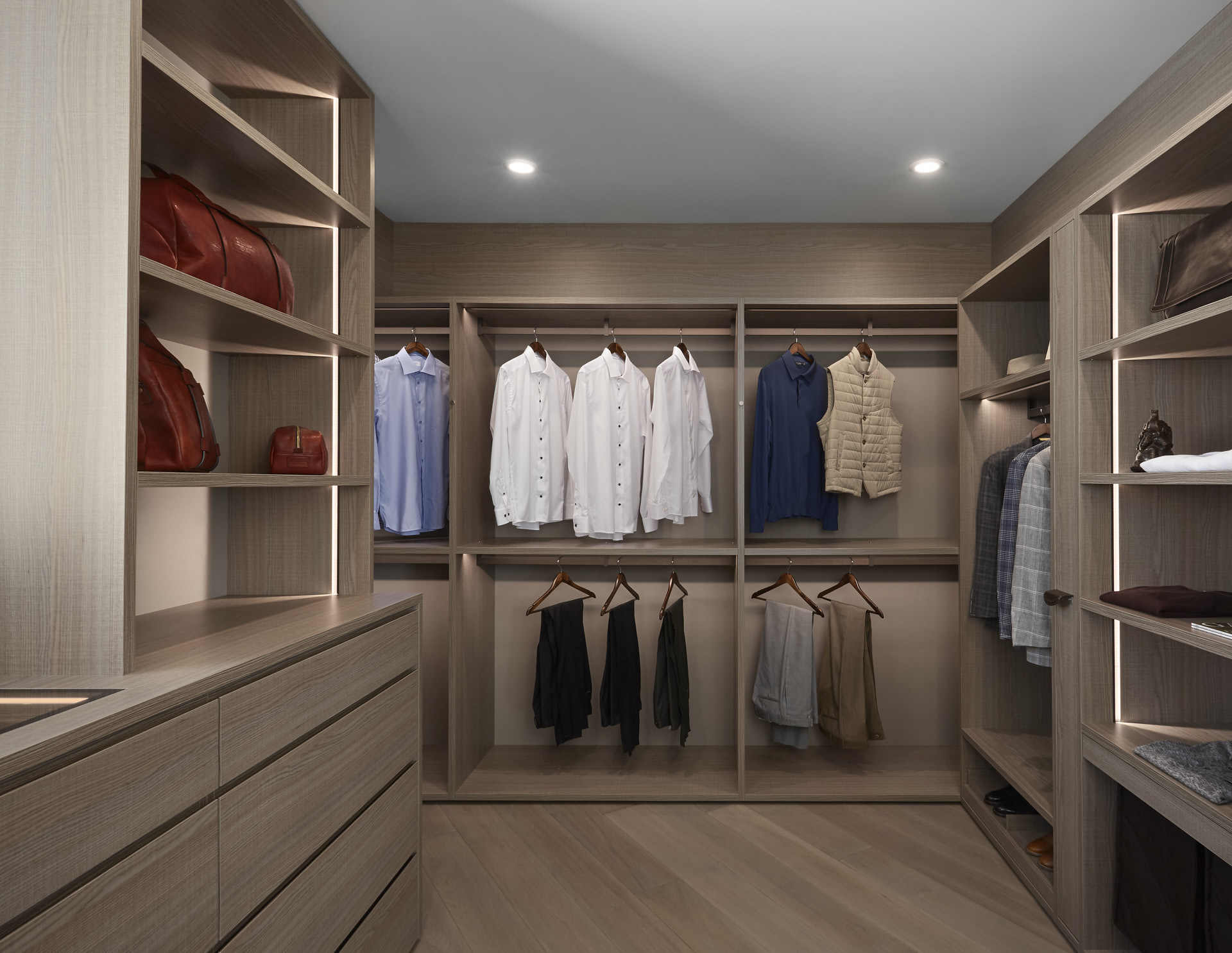 bespoke walk-in wardrobe using mid-tone finishes to achieve a masculine beachy feel