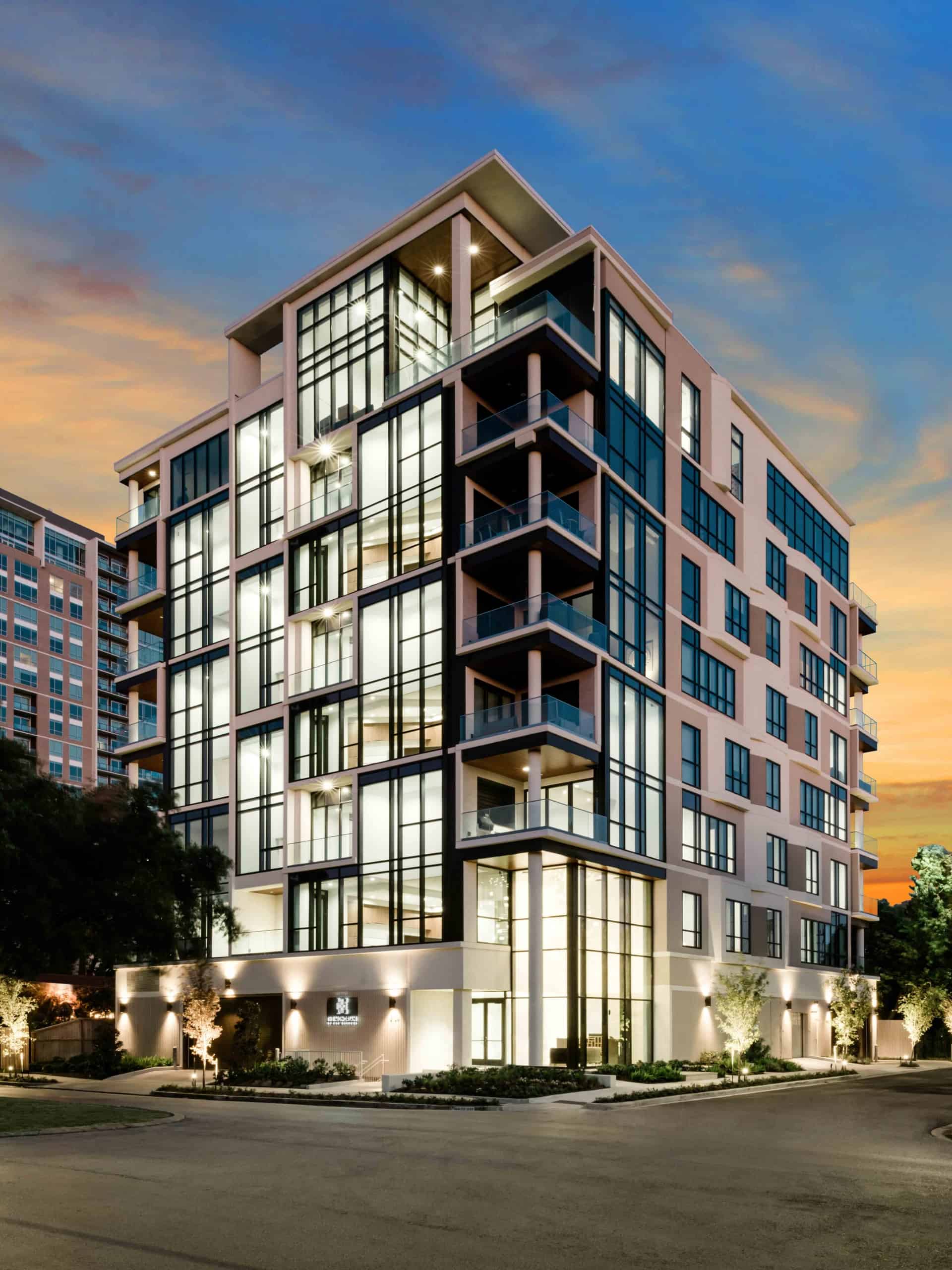 the mondrian luxury apartments in hermann park of houston with a sunset sky in the background