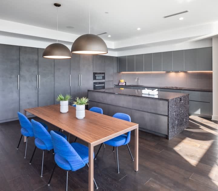 dining space and luxury stone kitchen in unit 601 at the mond luxury condos
