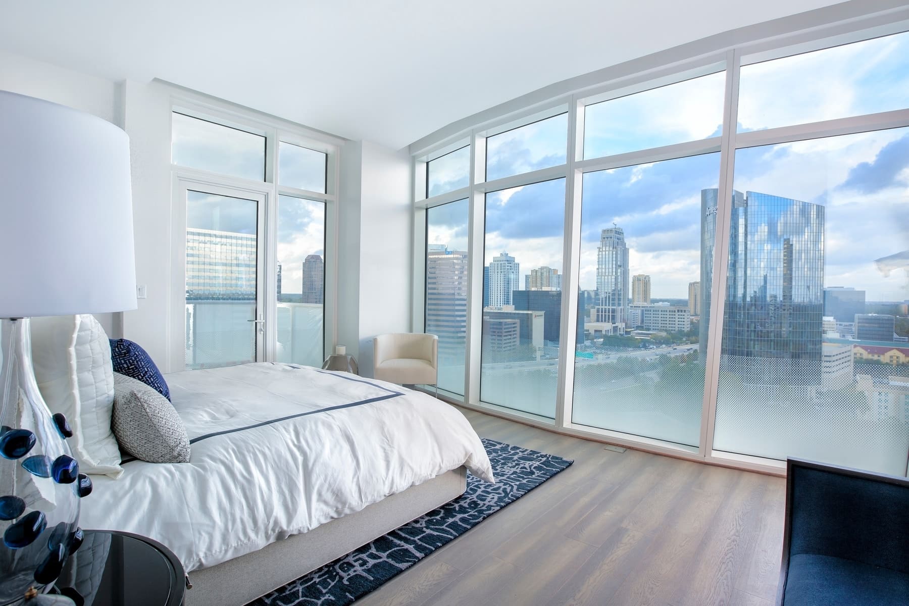 master bedroom with panoramic view of uptown houston from the model unit of arabella luxury condos in houston