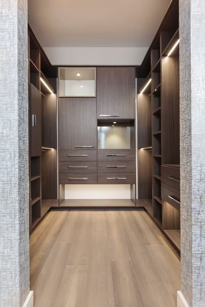 master walk-in closet using schmalenbach cabinetry in the model unit of arabella high rise condos in houston