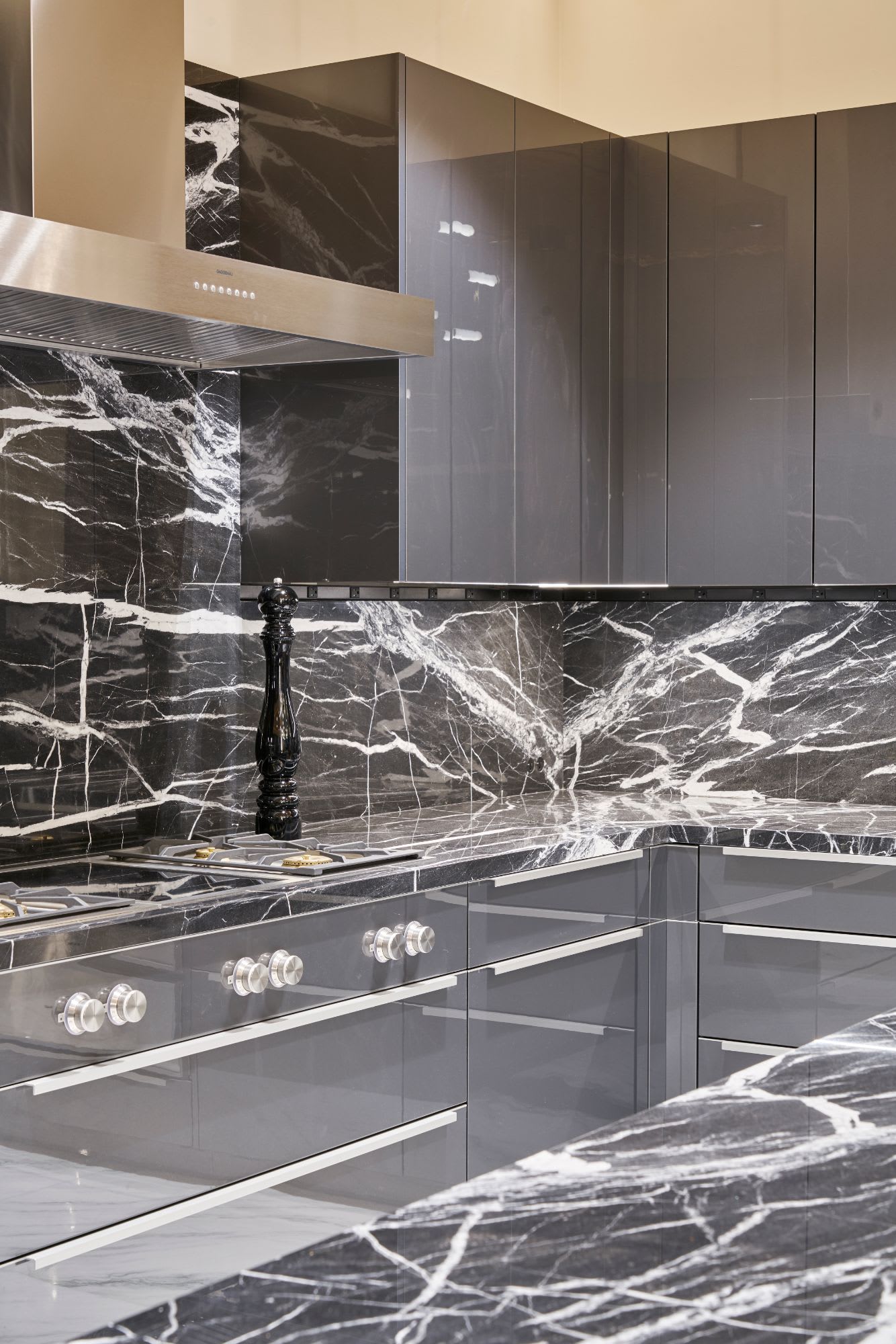 eggersmann kitchen with white-veined black marble and high-end gaggenau appliances featuring dark laminate upper cabinetsinside a penthouse of the arabella luxury high rise in houston