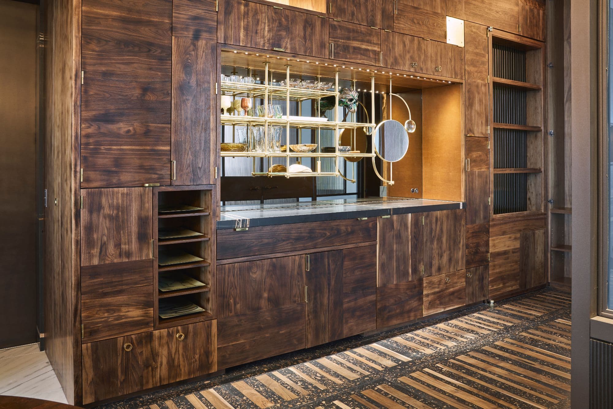 custom cabinetry providing a bar and ample storage in the hallway area inside a penthouse of the arabella luxury high rise in houston