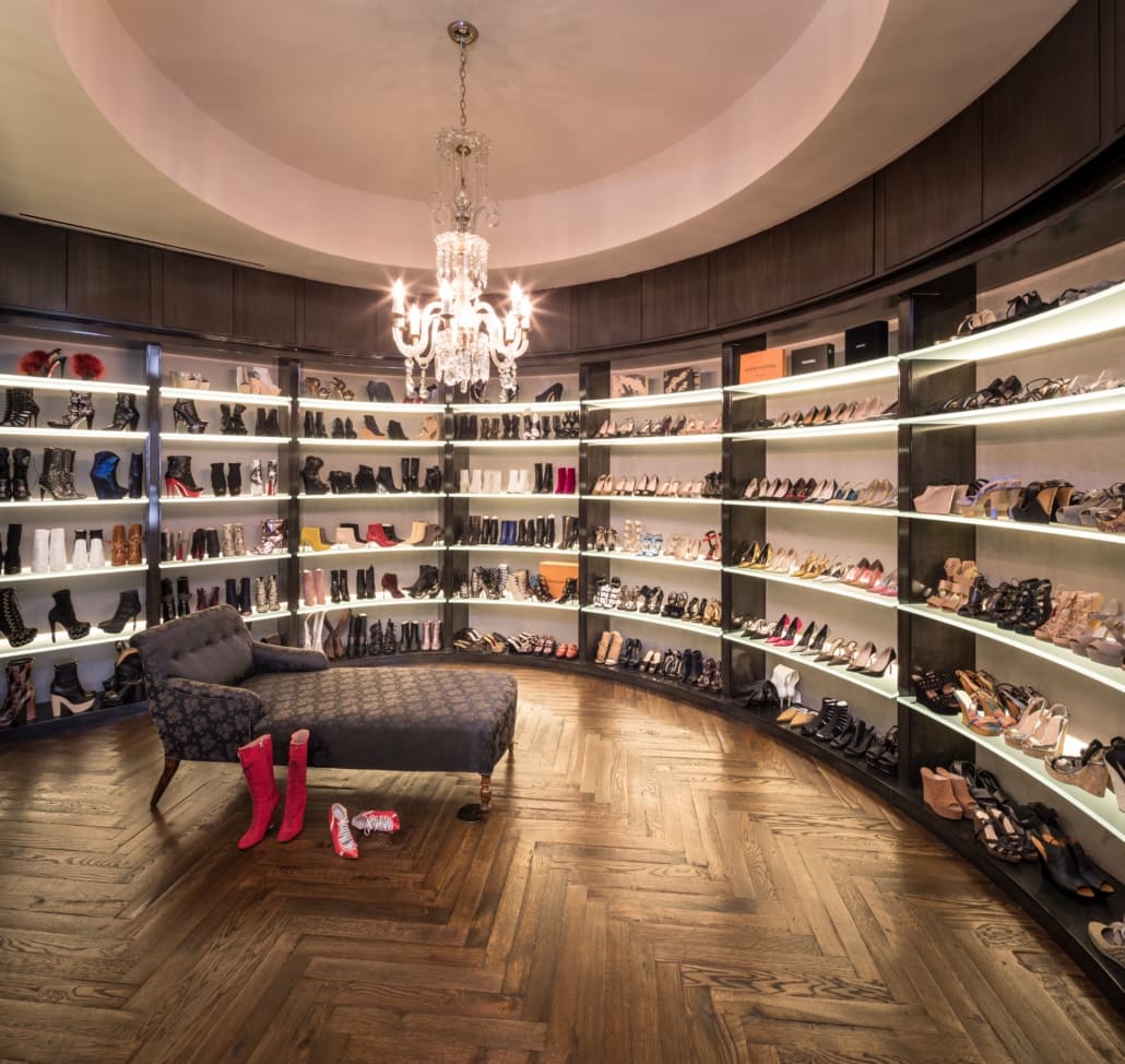 expansive luxury shoe storage in a high-end walkin closet of a full floor renovation of the huntingdon higrise on kirby in houston