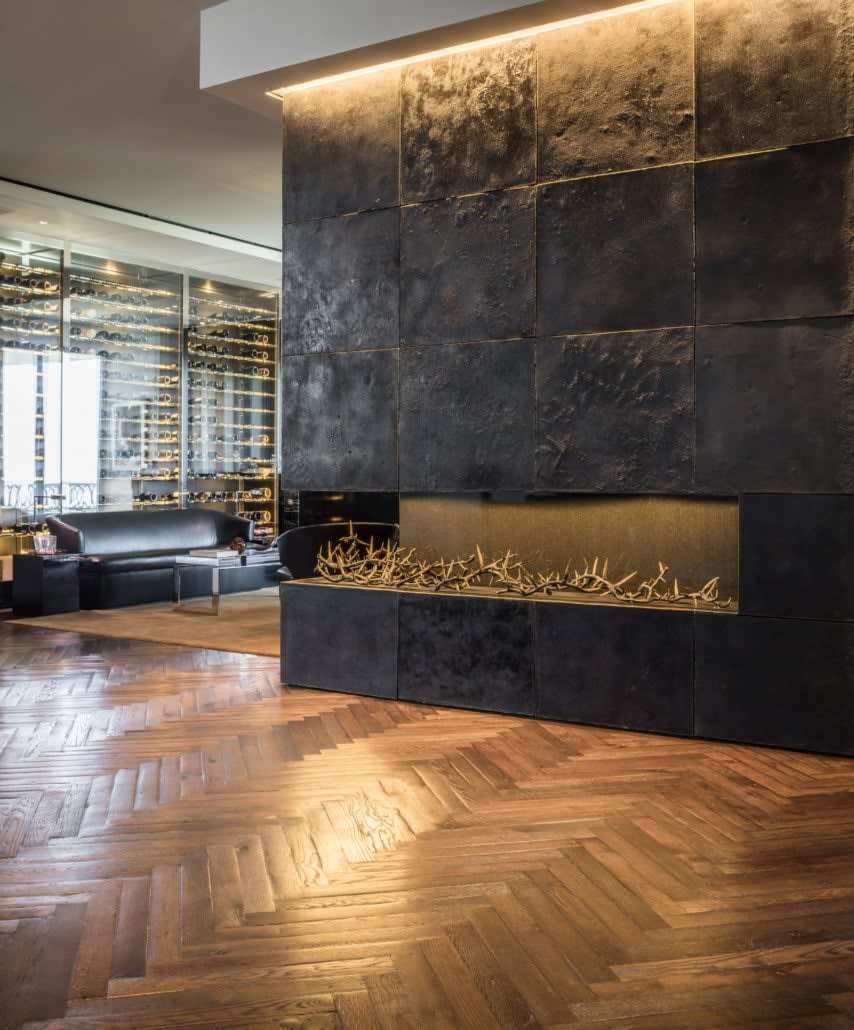 impressive architectural fireplace in a luxury lounge of a full floor renovation of the huntingdon higrise on kirby in houston