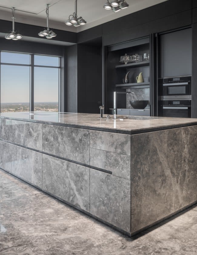 contemporary stone kitchen with ample hidden storage in the huntingdon luxury high-rise condos on kirby in houston
