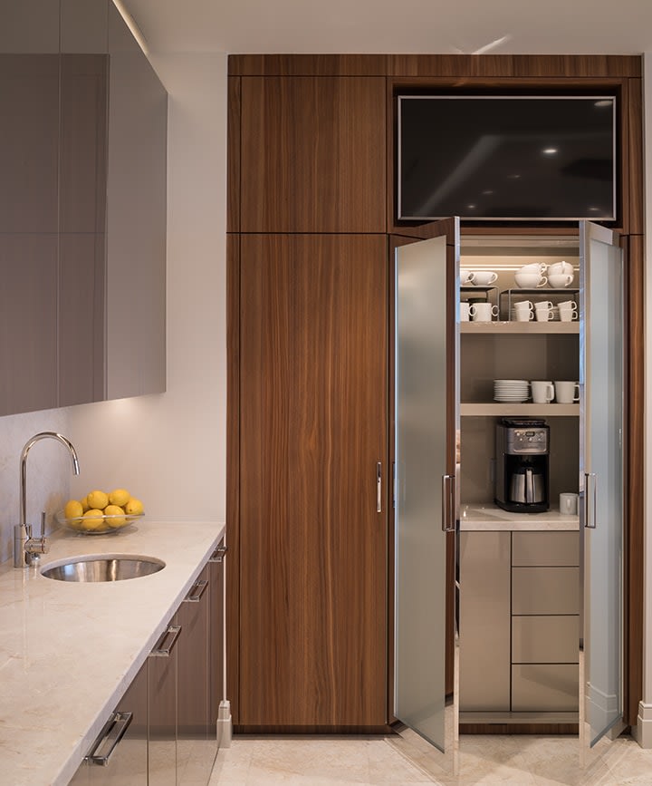 coffee bar behind glass doors in custom-designed kitchen in the warwick towers high-rise luxury condos