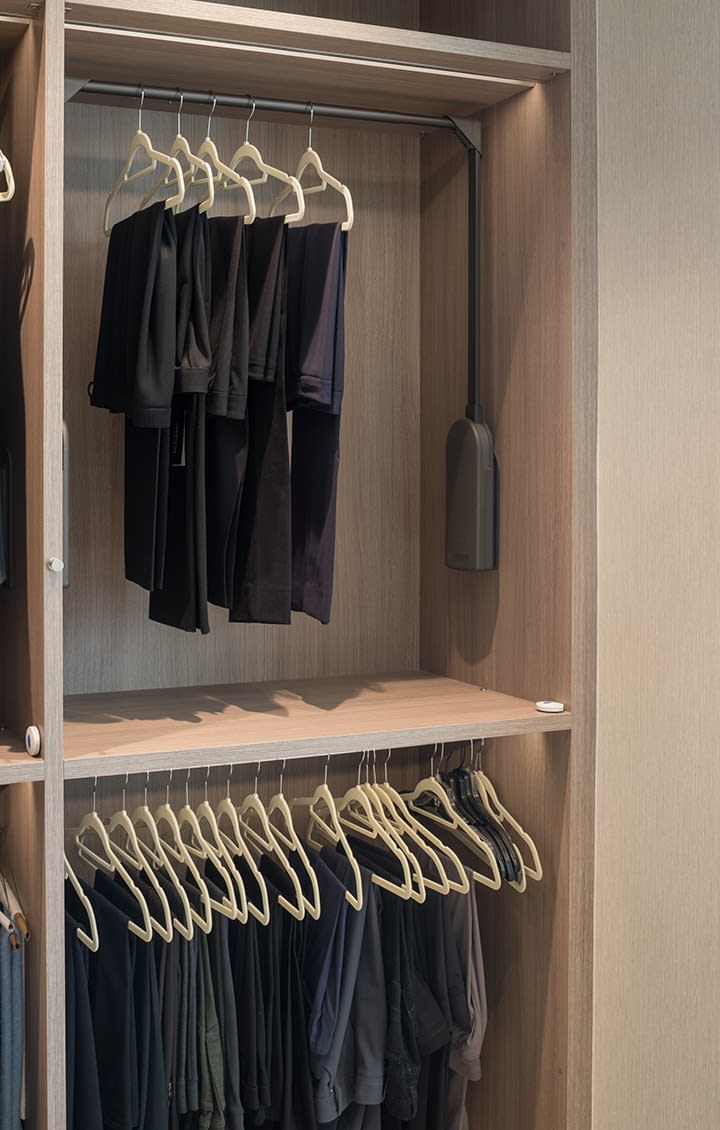 double clothes hanging in a Schmalenbach closet for her