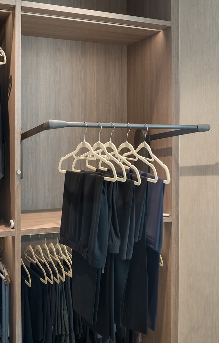 push-button automatic tilt-down clothes hanging in a Schmalenbach closet for her
