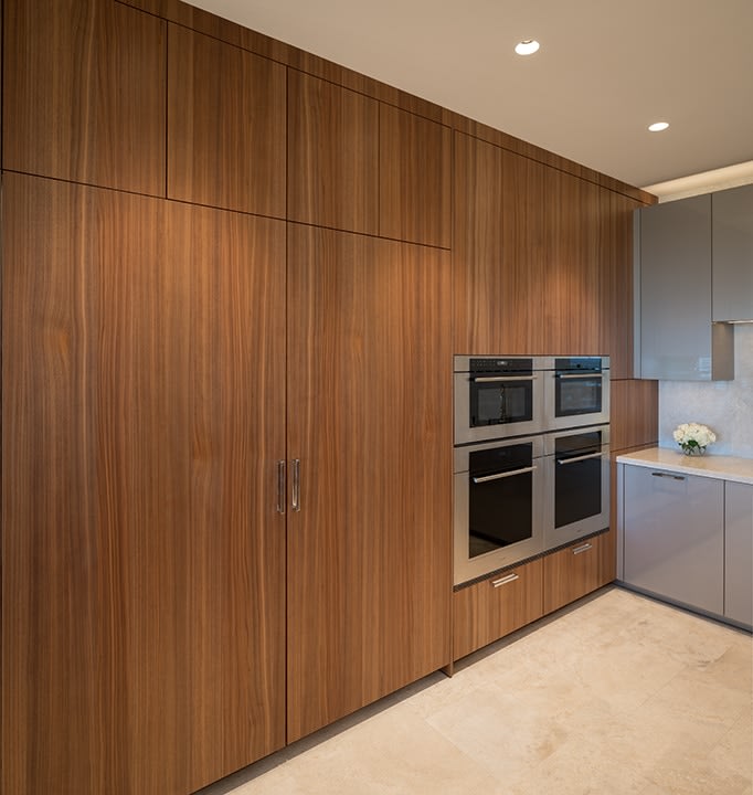 floor-to-ceiling storage in wood tones with wolf appliance collection in an eggersmann kitchen in belfiore condos in houston
