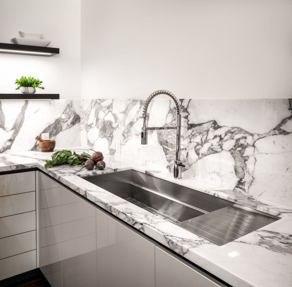 gooseneck pot-filler mounted faucet above a sink by the galley in a german kitchen designed by eggersmann for the paramount highrise in houston