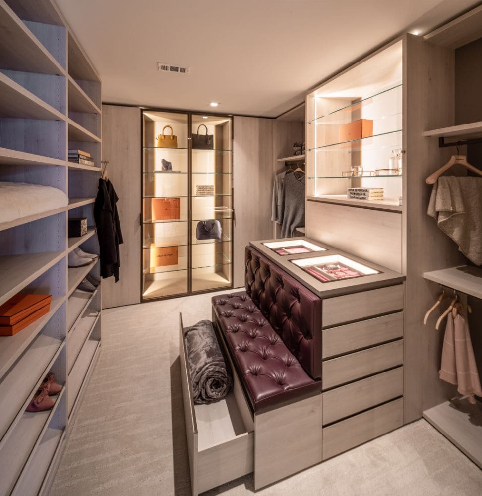 tufted leather bench in custom luxury wardrobe designed by eggersmann and crafted by schmalenbach features hidden drawer for storage