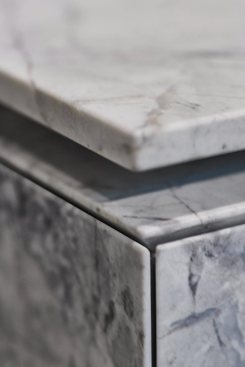 closeup of precision mitered detail of eggersmann unique cabinetry in Bianco Nuvola marble stone finish