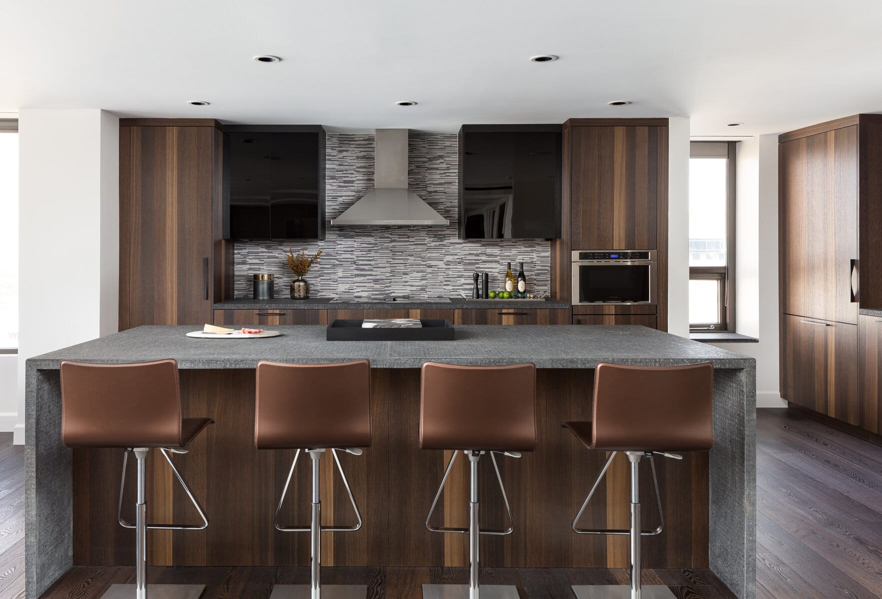 Entertaining Island with a Backdrop of Custom Hood and Black Glass Fronts