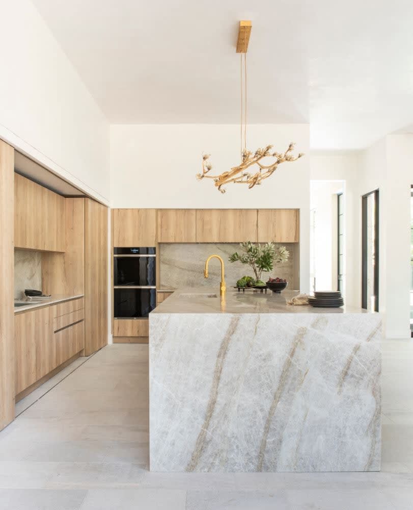 waterfall countertop island in taj mahal marble with leathered finish