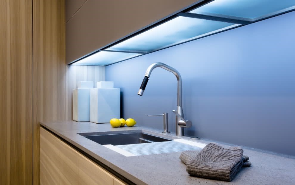 sleek under-cabinet led lighting gives the perfect glow to this luxury bar sink