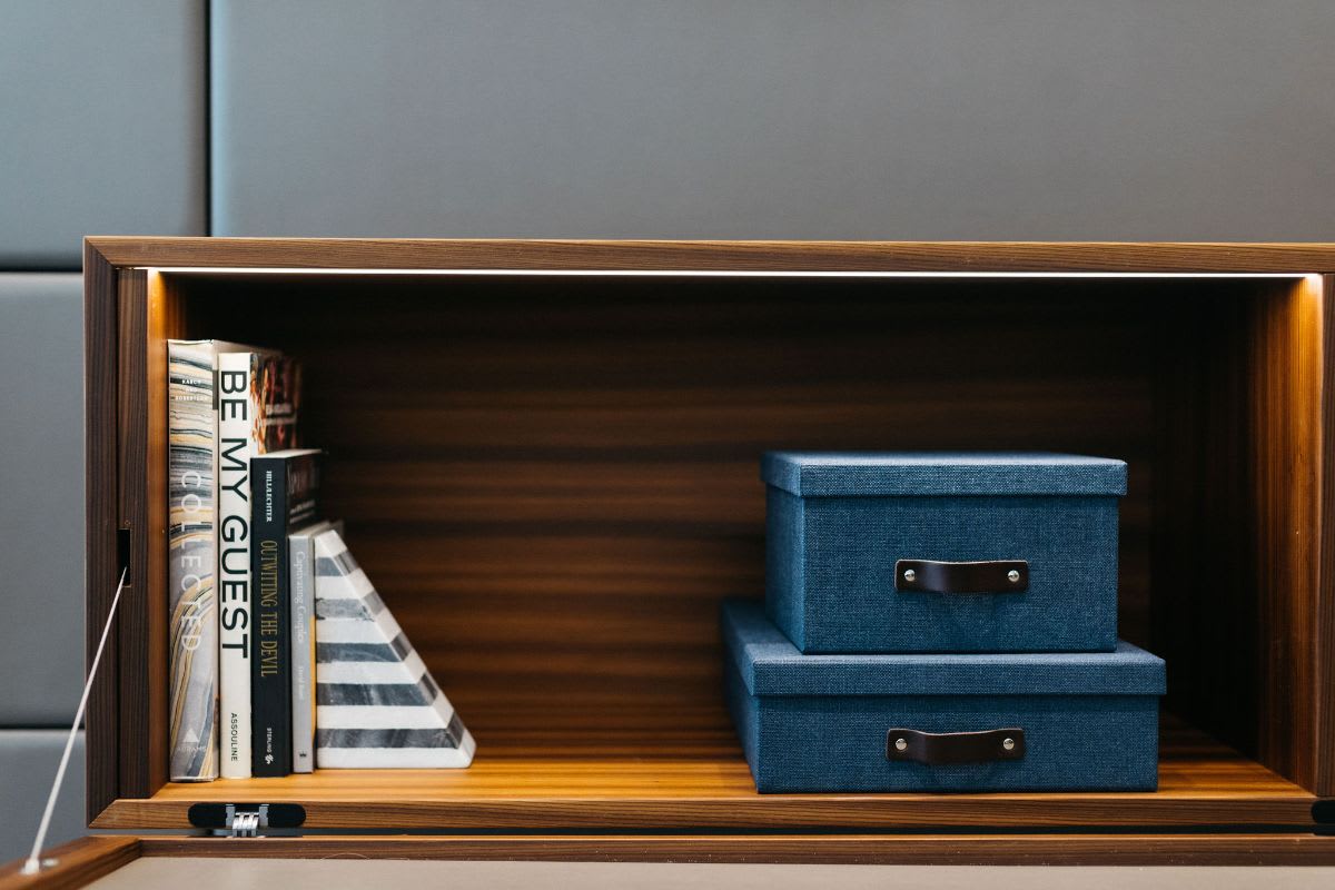 led lighting inside hidden storage cabinet on a media wall unit designed by eggersmann