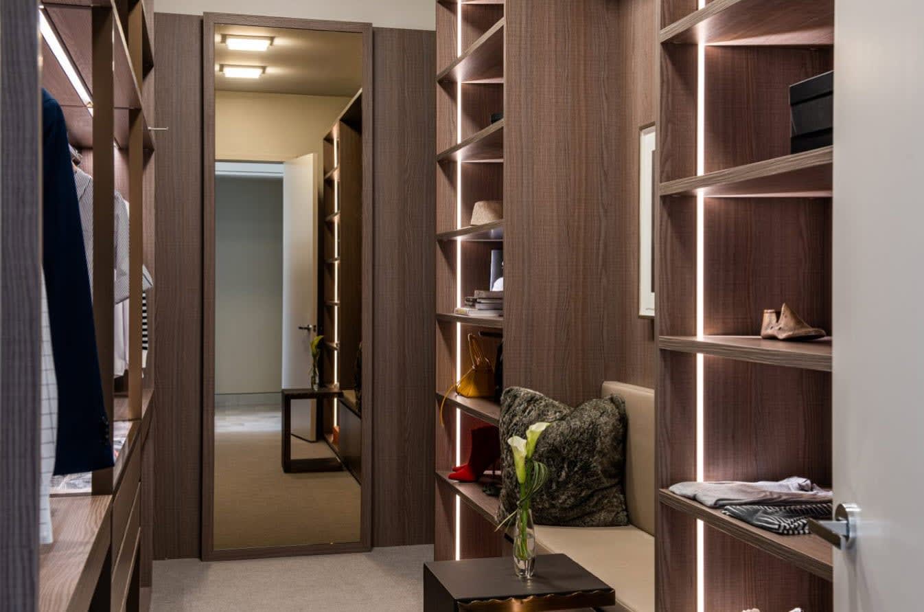 luxury walk-in closet featuring built-in led lightingdesigned by eggersmann and custom manufactured by schmalenbach for hall arts residences in dallas texas