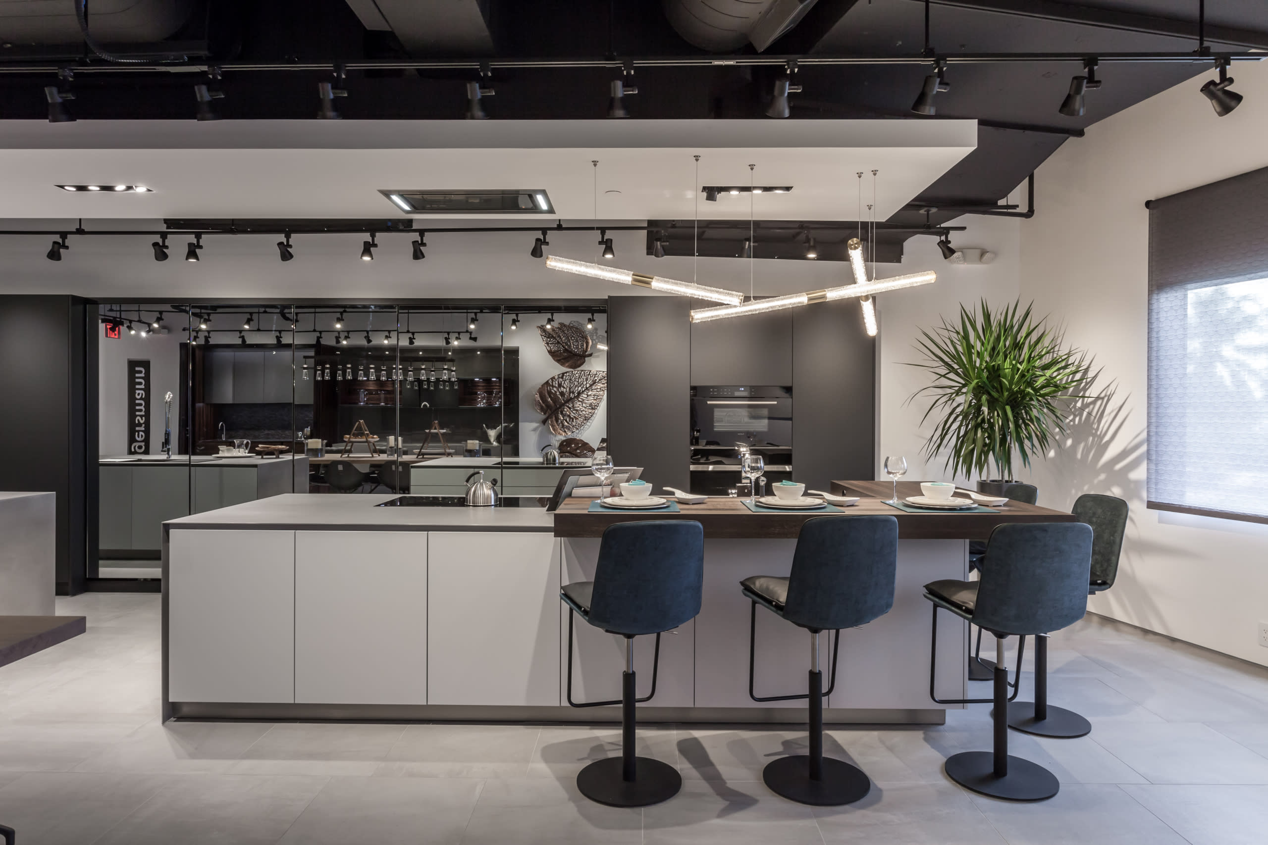 unique ultra-modern shakuff lighting constructed from 3 separate yard-long light tubes suspended at varying angles to create an island chandelier