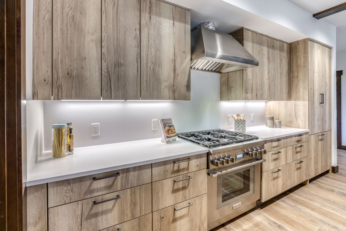 tahoe beach club master kitchen with rustic veneer fronts and ultra-modern countertops with matching backsplash