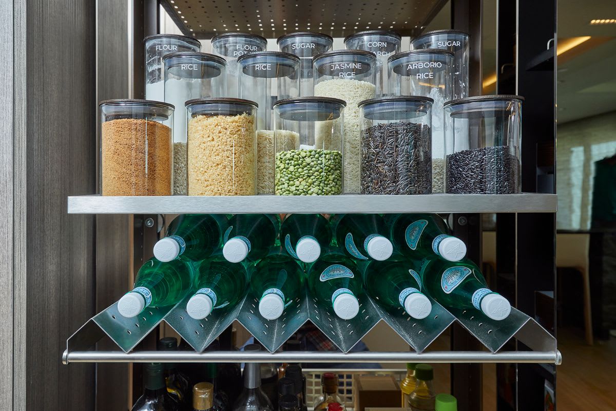 eggersmann's works turnstile pantry with labeled glass jar storage and custom beverage holder