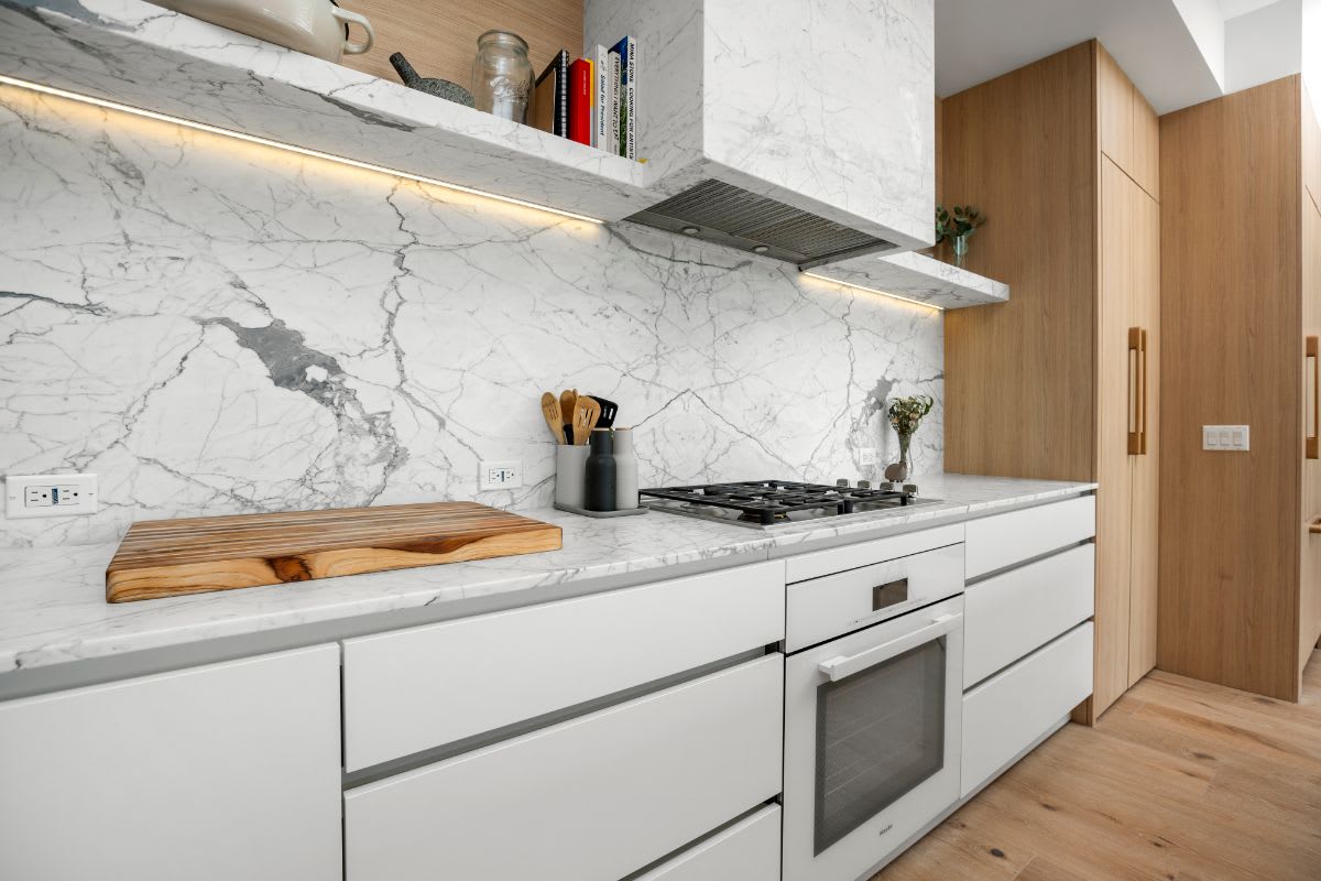 integrated range hood encased in marble in a luxury kitchen designed by eggersmann in la silver lake
