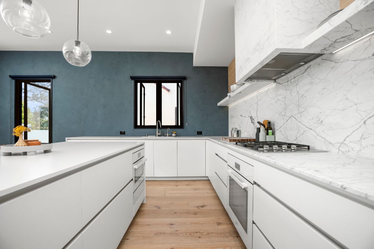 white kitchen with tactile dark painted accent wall in a luxury kitchen designed by eggersmann in la silver lake