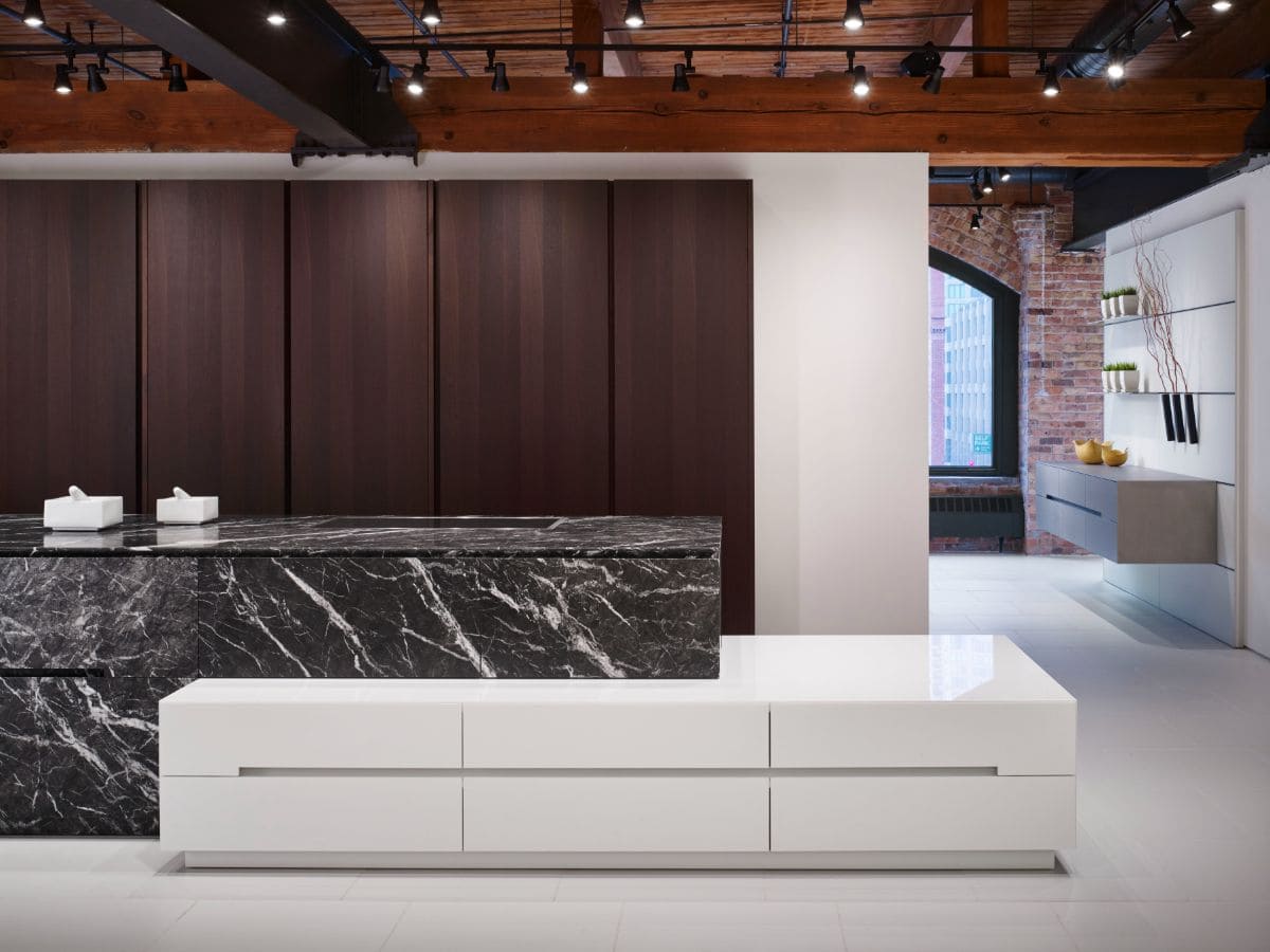 pocket doors on pantries of this luxury modern kitchen hide clutter when closed