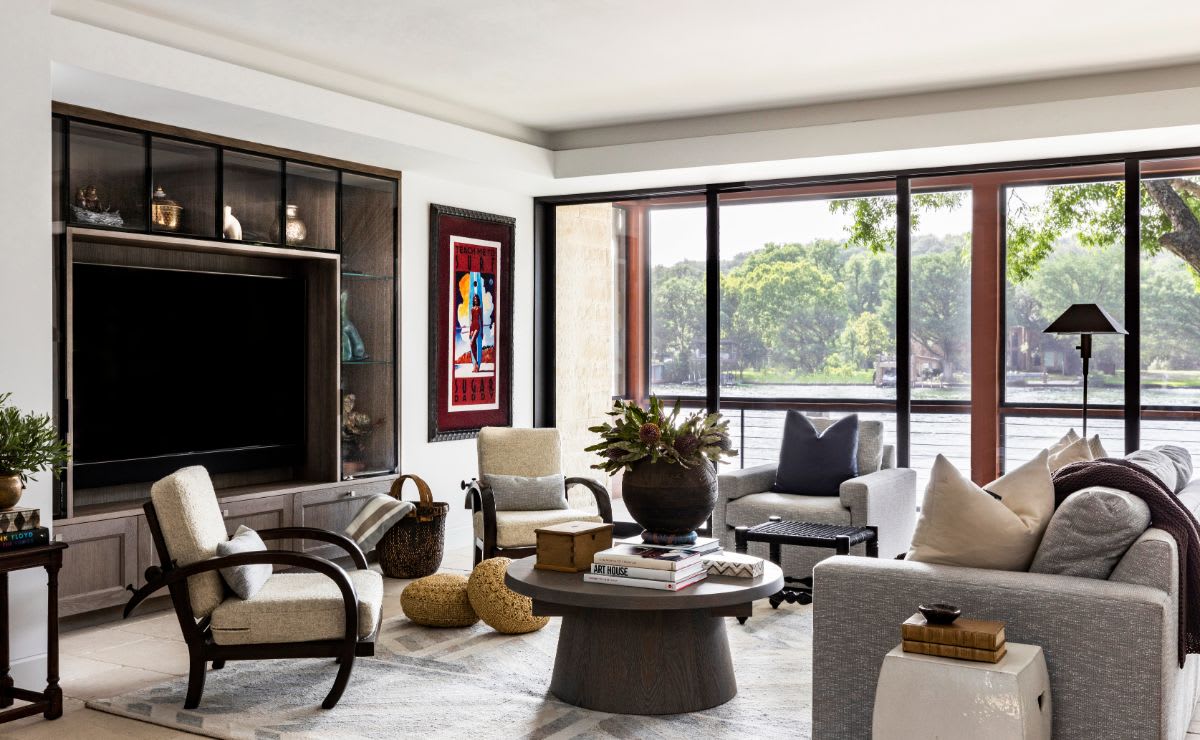 living area of a luxury austin home featuring a media unit with art niches designed by eggersmann using schmalenbach german cabinetry