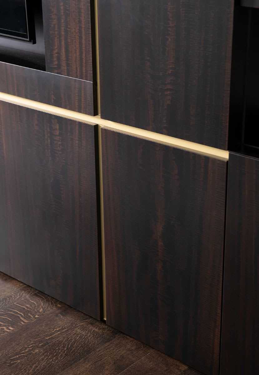 metallic reveal detail on a medial wall in the family room of a dallas preston hollow mansion after renovation by eggersmann