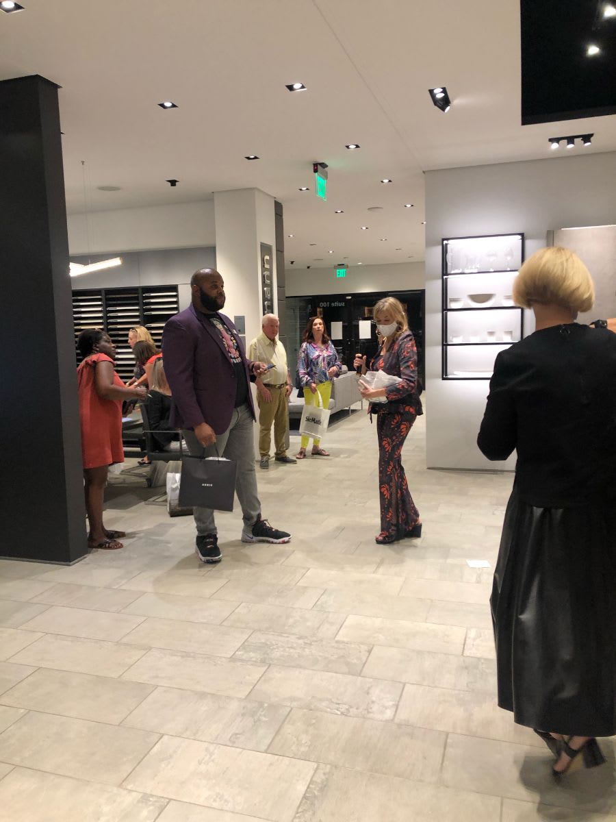 attendees exploring art and the eggersmann dallas showroom during curated 2021 art exhibition and dallas design district showroom tour