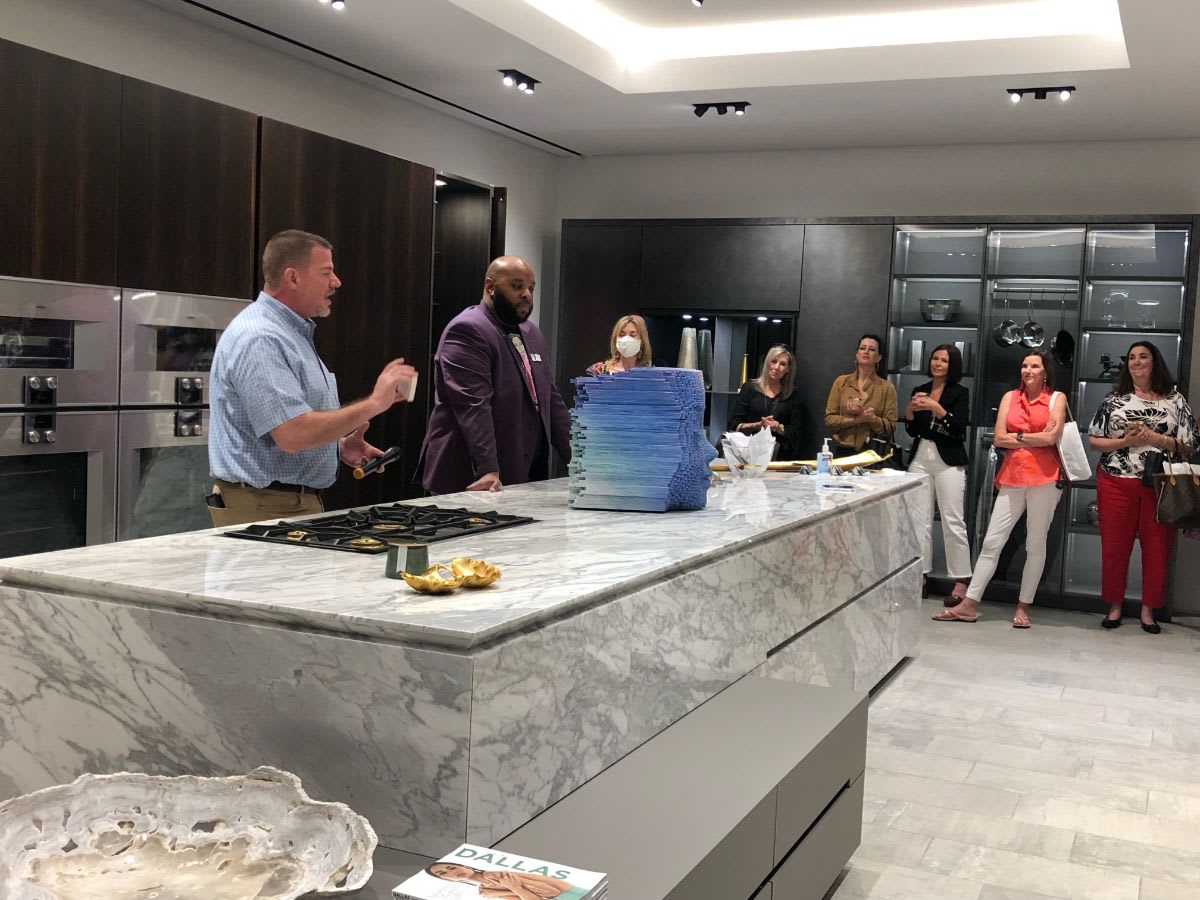 attendees eagerly waiting the raffle winner annoucement at curated 2021 art exhibition and dallas design district showroom tour