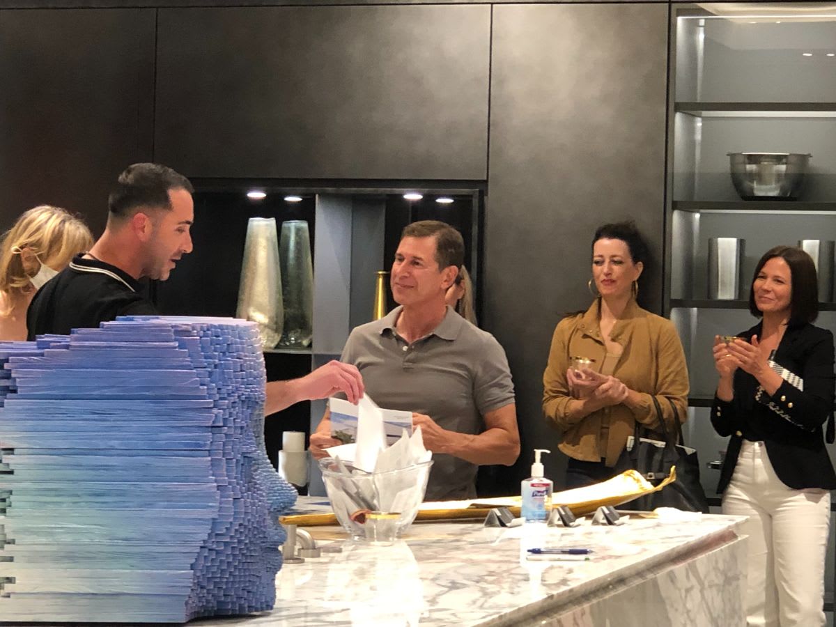 attendees entering the raffle at curated 2021 art exhibition and dallas design district showroom tour