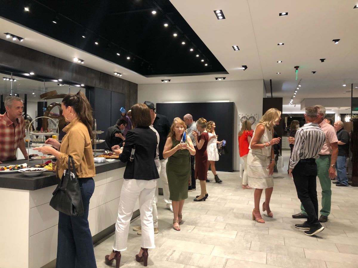 attendees enjoying the refreshments at curated 2021 art exhibition and dallas design district showroom tour