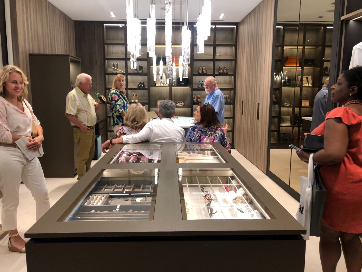 attendees exploring the schmalenbach luxury walk-in closet during curated 2021 art exhibition and dallas design district showroom tour