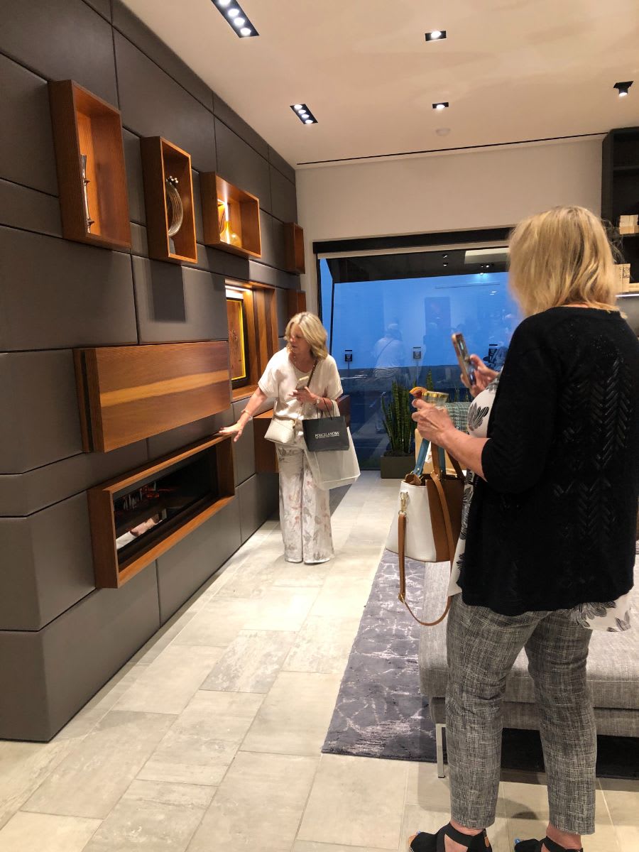 attendees exploring the media wall display at eggersmann dallas during curated 2021 art exhibition and dallas design district showroom tour
