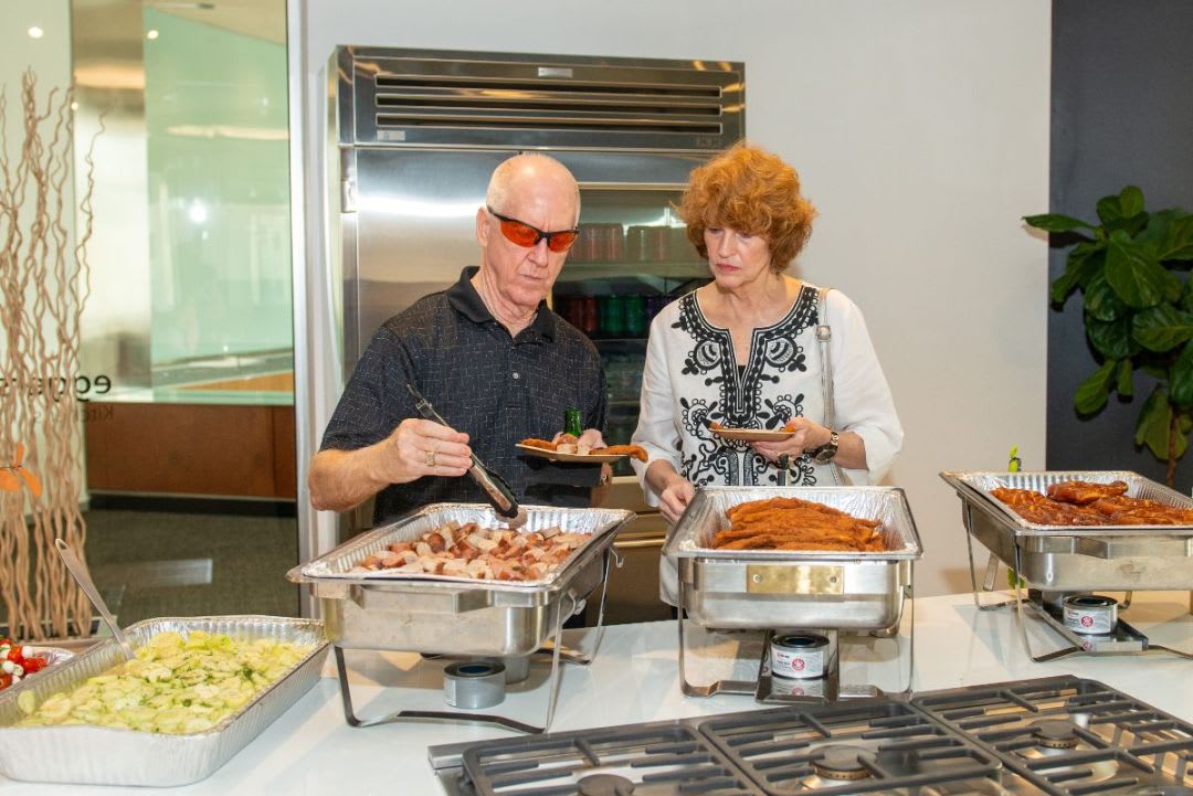 frankfurt kitchen event attendees filling their plates with german food from the buffet at the eggersman houston showroom event