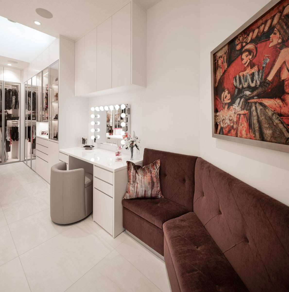 tufted upholstered bench in a luxury walk-in closet designed for the lady of a sugar lakes home in sugar land texas