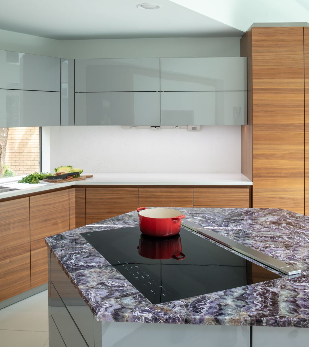 very peri colored stone island with inset cooktop