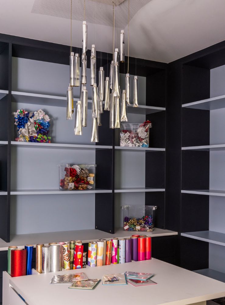 high-end craft room with gift-wrapping station designed for a belfiore homeowner