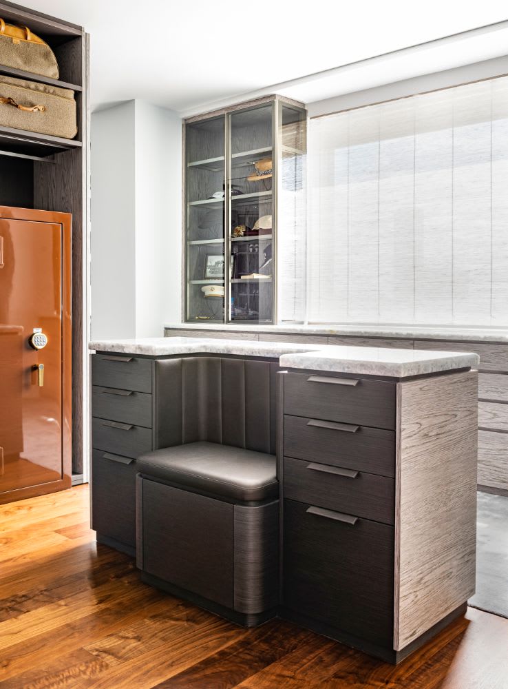 a masculine closet island featuring a bench