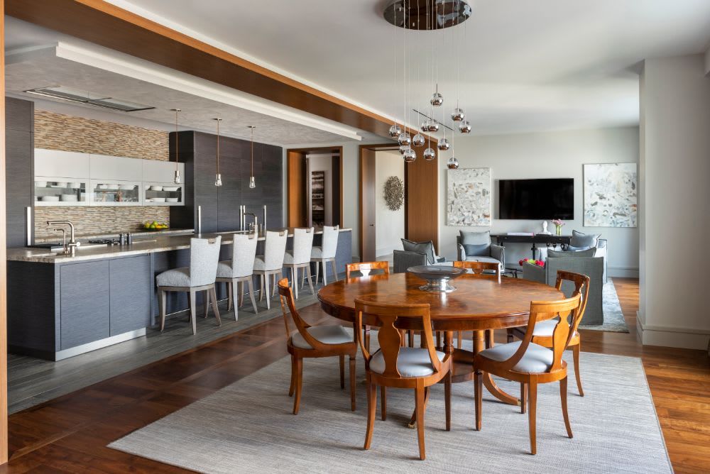 dining area and central kitchen designed by eggersmann for this belfiore condo in houston