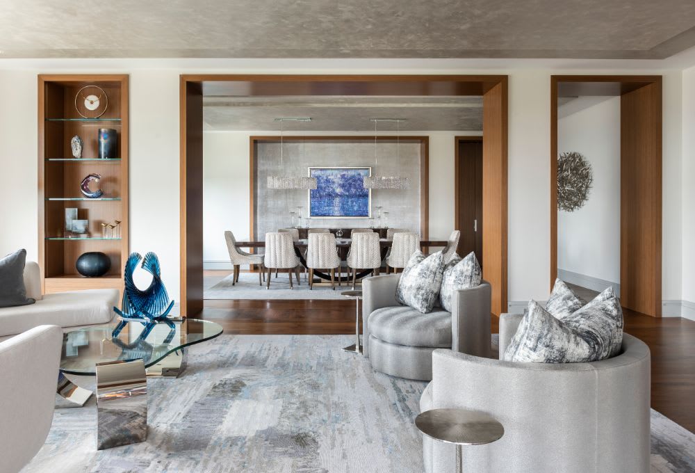 living area of a belfiore houston penthouse feature custom built-in wood shelving living area of a belfiore houston penthouse feature custom built-in wood shelving